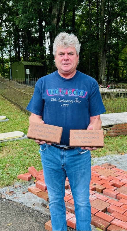 Joey Morgan shows the bricks he purchased for his parents and grandparents. 